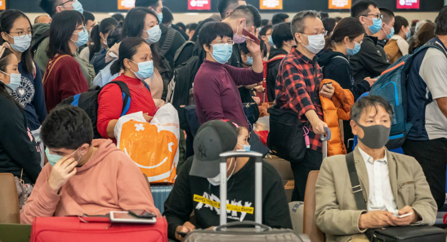 Travelers wearing face masks in Hong Kong because of Wuhan coronavirus infections. | Getty Images