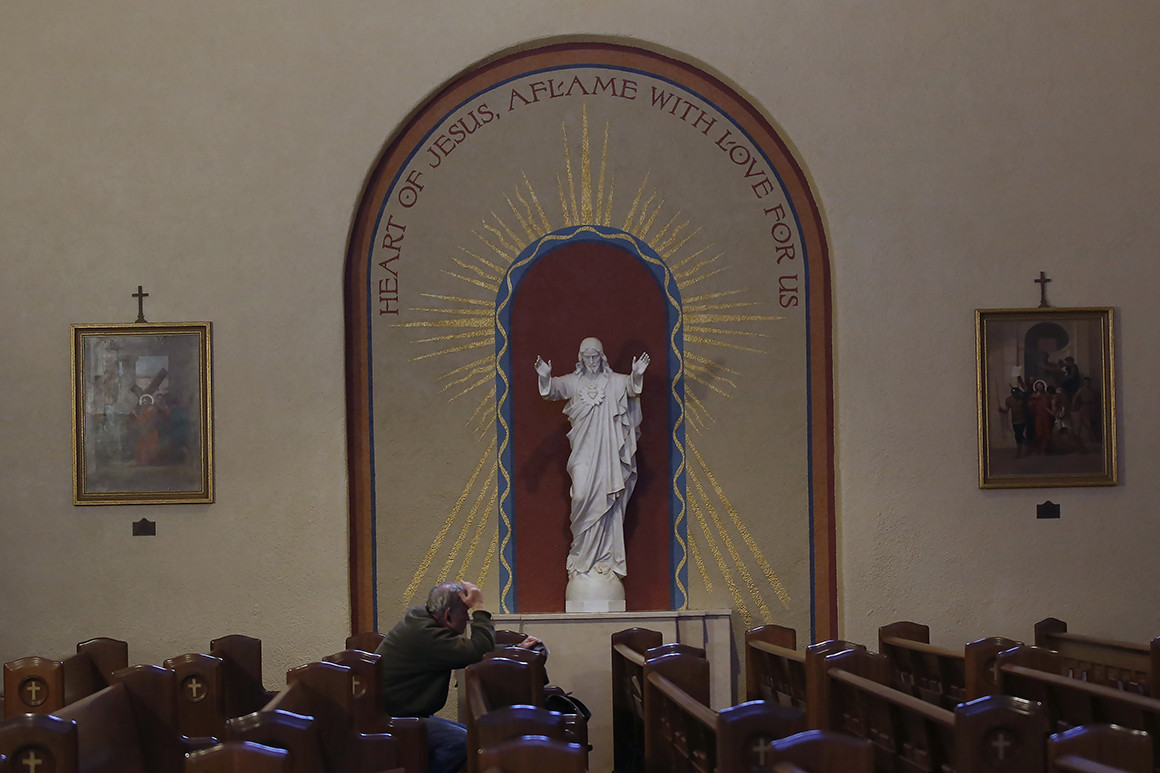 A man attends service in a church in Sacramento | AP Photo