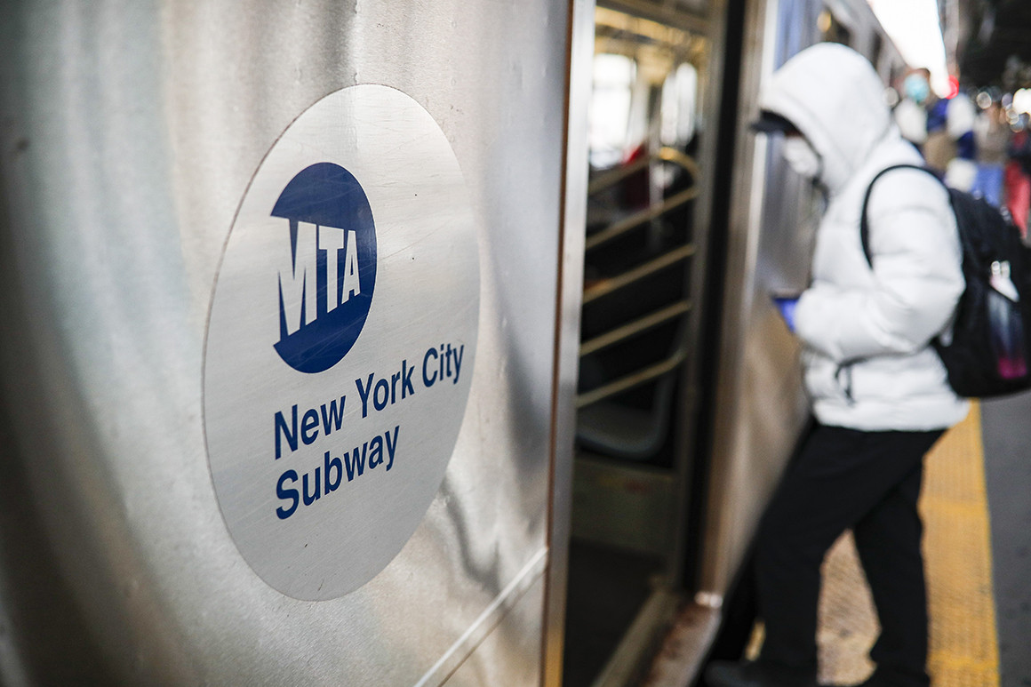 A person wearing a mask steps onto a New York City subway car | AP Photo