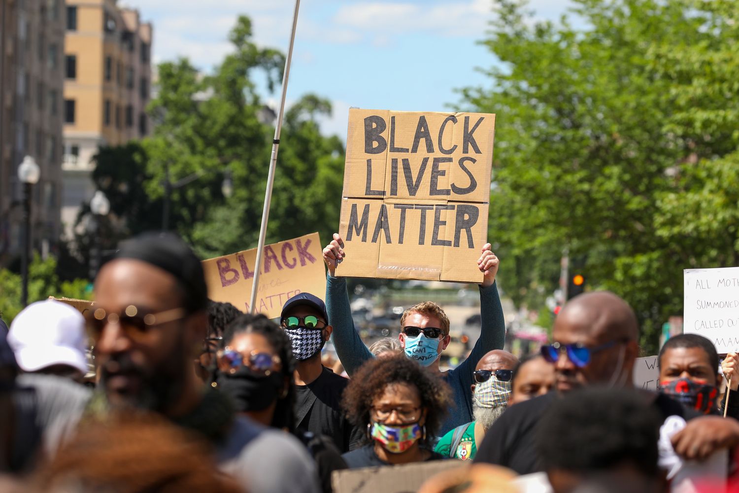 A protester holds a Black Lives Matter sign